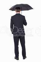Rear view of a businessman under umbrella