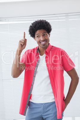 Happy businessman pointing up with finger