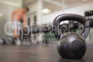 Focus on large black kettlebell in weights room