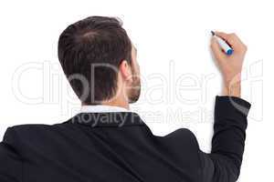 Rear view of businessman writing with marker