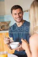 Cute couple having cereal for breakfast