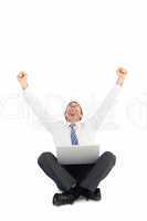 Businessman using laptop and cheering