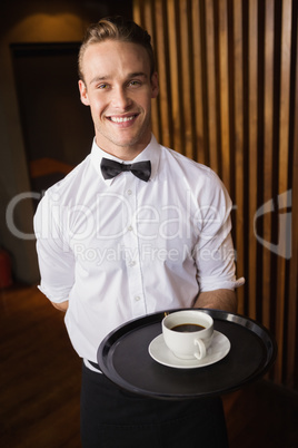 Waiter holding tray with coffee cup