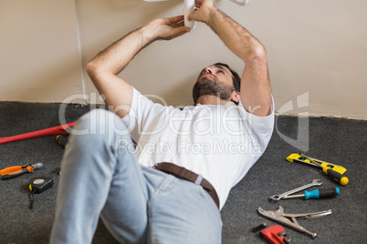 Plumber fixing the sink in a bathroom