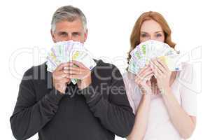 Casual couple showing their cash