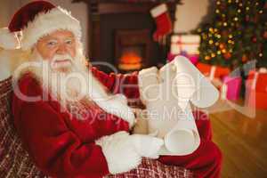 Smiling santa claus reading his list