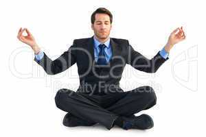 Calm businessman sitting in lotus pose