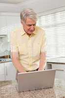 Senior man using his laptop