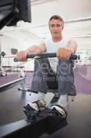 Fit man working out on rowing machine