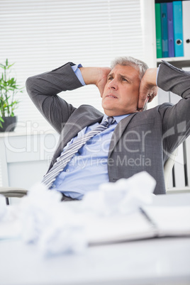 Stressed businessman covering his ears