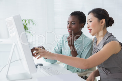 Businesswomen working together at desk