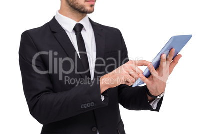 Mid section of a businessman using digital tablet pc