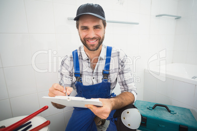 Plumber taking notes on clipboard