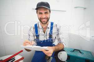 Plumber taking notes on clipboard