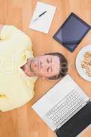 Man lying on floor surrounded by various objects at home