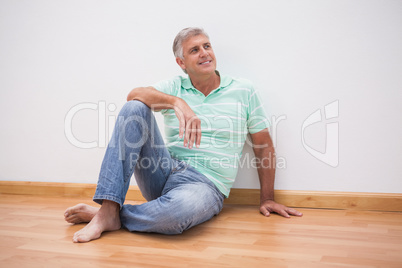 Mature man sitting on floor
