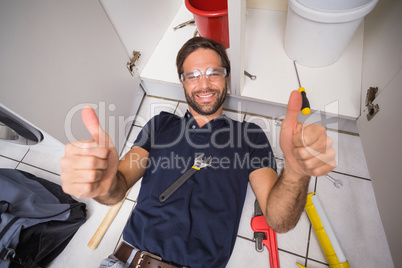 Plumber fixing under the sink