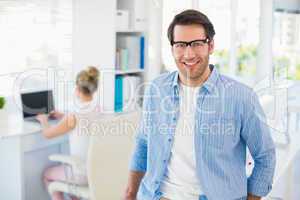 Portrait of smiling photo editor wearing reading glasses