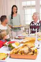 Woman holding christmas dinner with family at dinning table