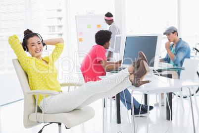 Young creative woman sitting with feet up