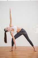 Fit brunette doing yoga at home