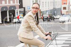 Young businesswoman riding her bike