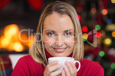 Pretty blonde relaxing on sofa at christmas