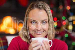 Pretty blonde relaxing on sofa at christmas