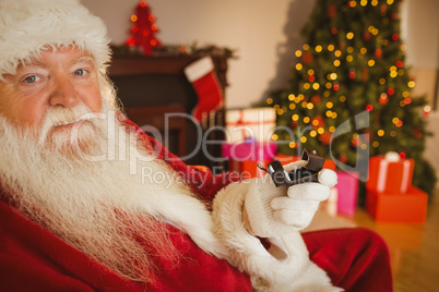 Father christmas holding engagement ring with his box