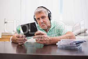 Mature man listening to cds