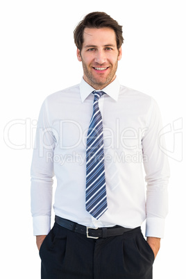 Smiling businessman standing with hands in pockets