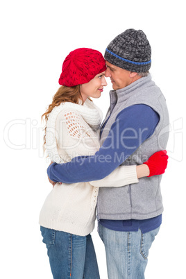 Happy couple in warm clothing hugging