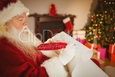 Santa claus writing his list on scroll