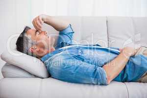 Man with grey hair relaxing on the couch