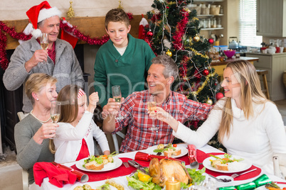 Family toasting each other at christmas