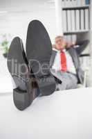 Relaxed businessman with his feet up