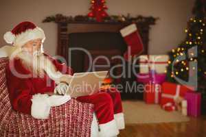 Santa using laptop on the couch at christmas