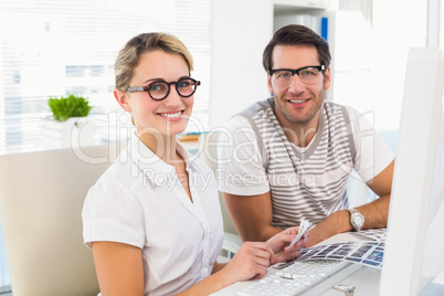 Smiling photo editors looking at camera