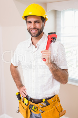 Handyman smiling at camera in tool belt