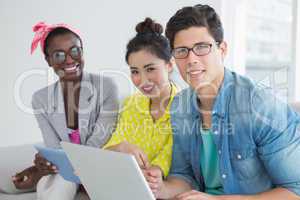 Young creative team working on couch