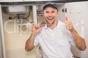 Plumber fixing under the sink