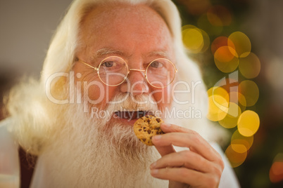 Happy santa claus eating a cookie
