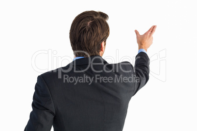 Rear view of young businessman in suit pointing Rear view of young businessman in suit pointing