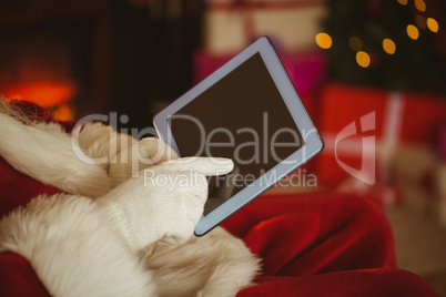 Santa claus touching tablet pc