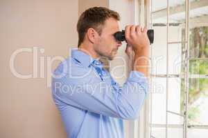 Man looking through a binoculars