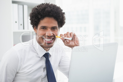 Portrait of a smiling businessman holding cigarette