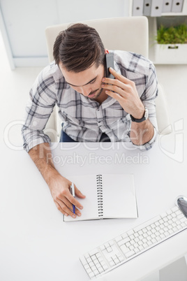 Casual businessman looking at notepad