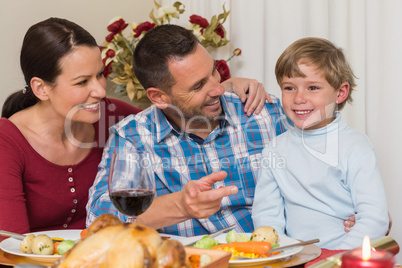Portrait of parents and son at christmas dinner