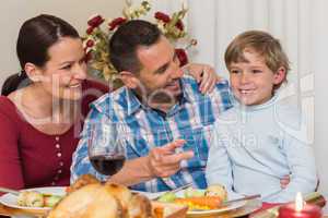 Portrait of parents and son at christmas dinner