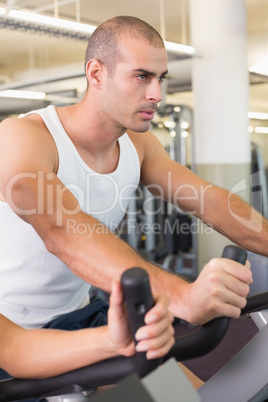 Man working out on exercise bike at gym